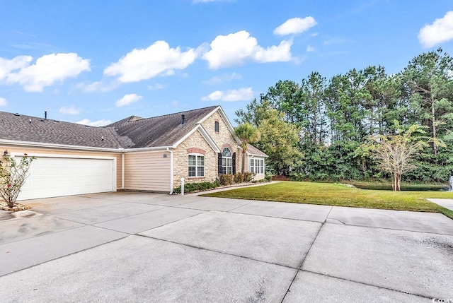 view of front of property featuring a garage and a front lawn