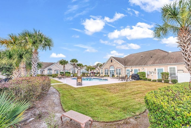 view of swimming pool with a lawn and a patio area