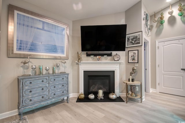 living room featuring vaulted ceiling and light hardwood / wood-style flooring