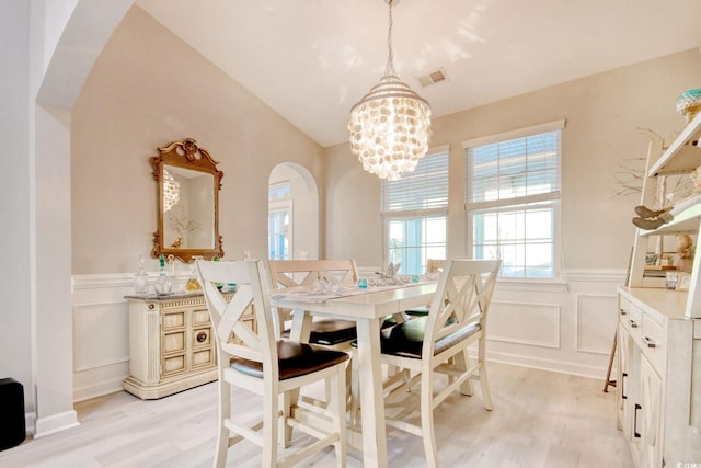 dining area featuring light hardwood / wood-style floors and an inviting chandelier