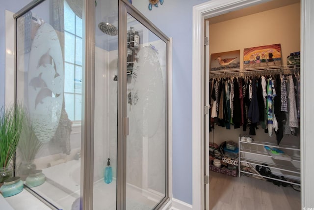 bathroom with wood-type flooring and walk in shower