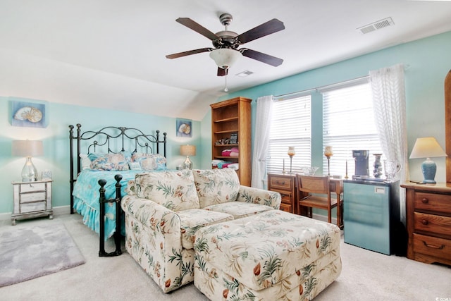 bedroom featuring light carpet, vaulted ceiling, and ceiling fan