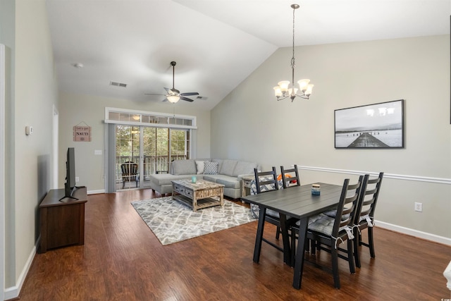 dining space with lofted ceiling, dark wood-type flooring, and ceiling fan with notable chandelier