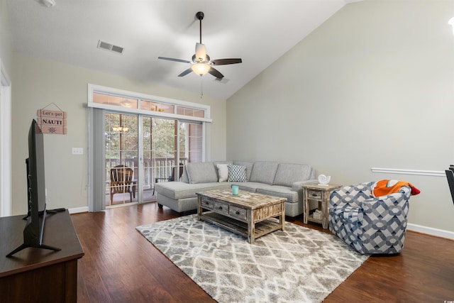 living room featuring dark wood-type flooring, vaulted ceiling, and ceiling fan