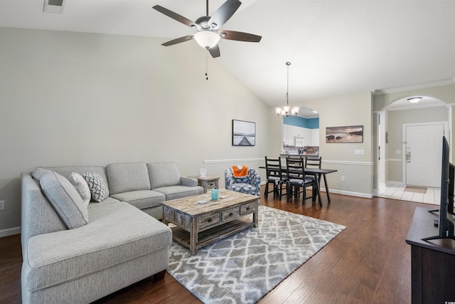 living room featuring lofted ceiling, ceiling fan with notable chandelier, and dark hardwood / wood-style flooring