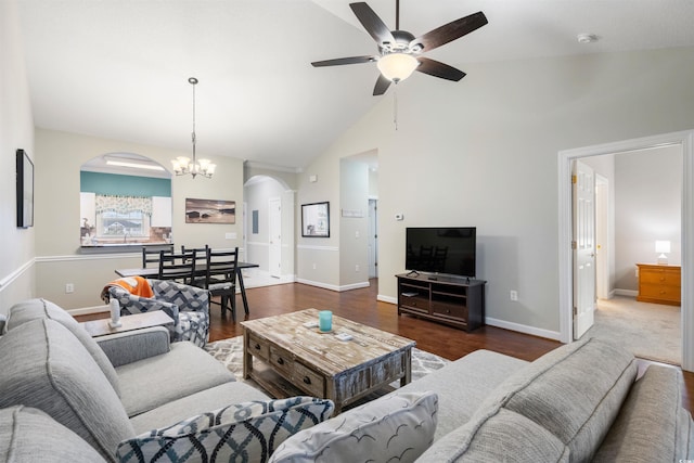 living room featuring dark hardwood / wood-style floors, high vaulted ceiling, sink, and ceiling fan with notable chandelier