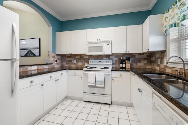 5750 Oyster Catcher Dr Unit 1134, North Myrtle Beach, SC 29582 - kitchen with a sink, white cabinetry, decorative backsplash, and white appliances