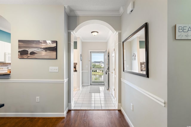 corridor with wood-type flooring and ornamental molding