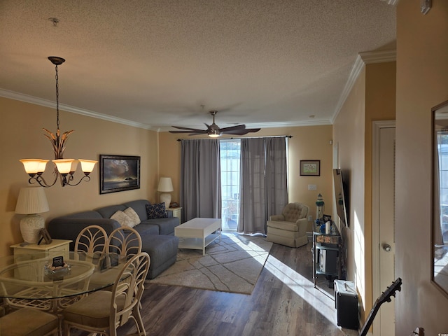 living room with crown molding, wood-type flooring, a textured ceiling, and ceiling fan with notable chandelier