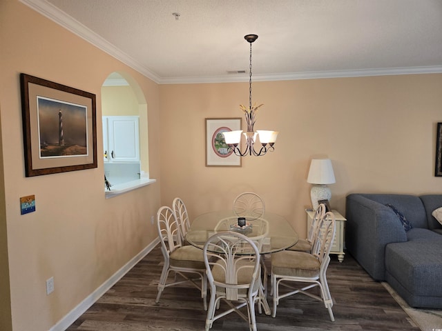 dining room with ornamental molding, a chandelier, and dark hardwood / wood-style flooring