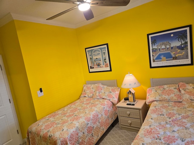 bedroom with ornamental molding, carpet, and ceiling fan