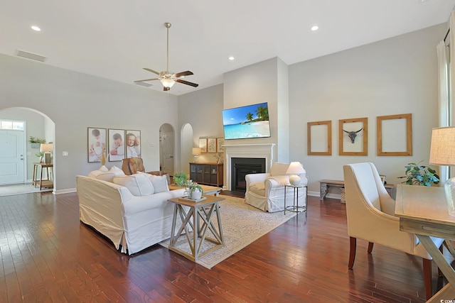 living room with ceiling fan and dark hardwood / wood-style floors