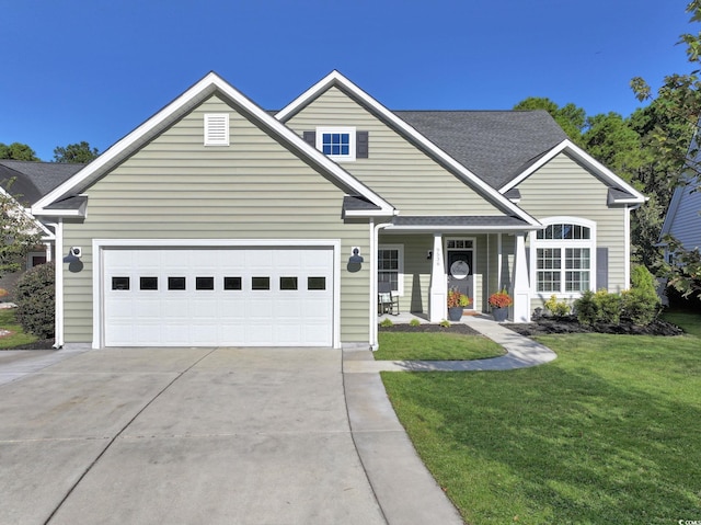 view of front of property featuring a front lawn and a garage