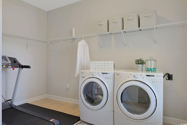 washroom with light tile patterned flooring and washer and clothes dryer