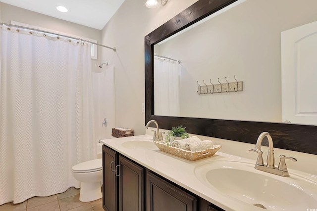 bathroom with tile patterned flooring, curtained shower, vanity, and toilet