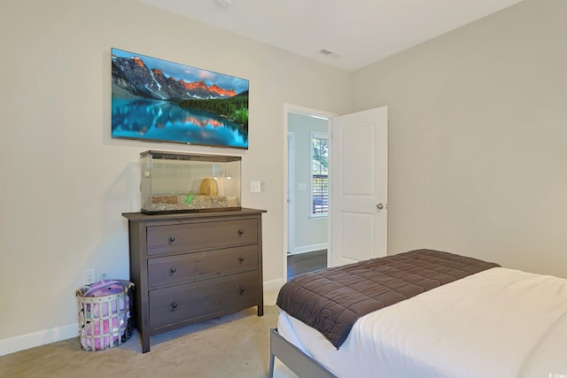 bedroom featuring light carpet