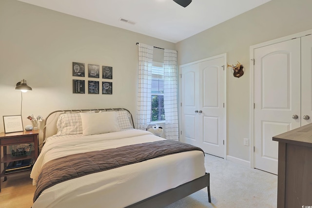 bedroom featuring light carpet and ceiling fan