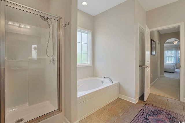 bathroom with a wealth of natural light, tile patterned floors, and shower with separate bathtub