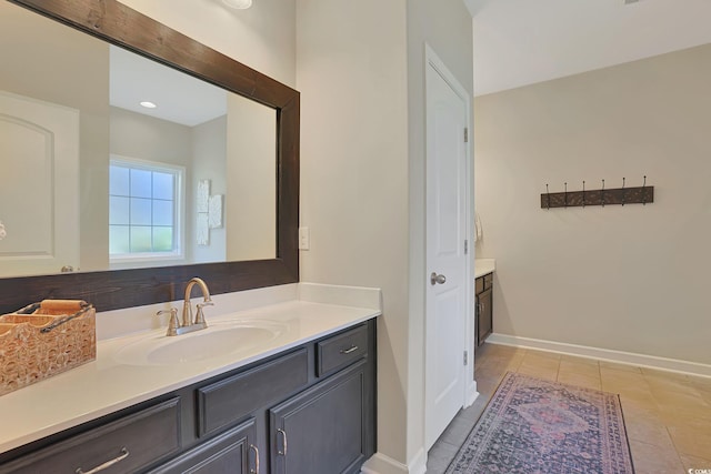 bathroom featuring tile patterned flooring and vanity