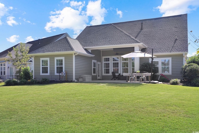 rear view of house with a patio, a yard, and ceiling fan