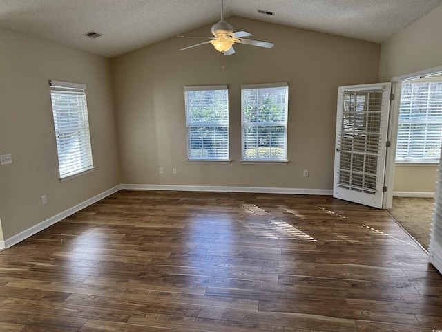 spare room featuring ceiling fan, a textured ceiling, dark hardwood / wood-style floors, and lofted ceiling