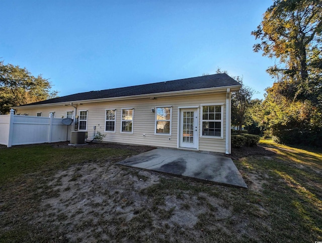 back of house featuring a patio area, central air condition unit, and a lawn