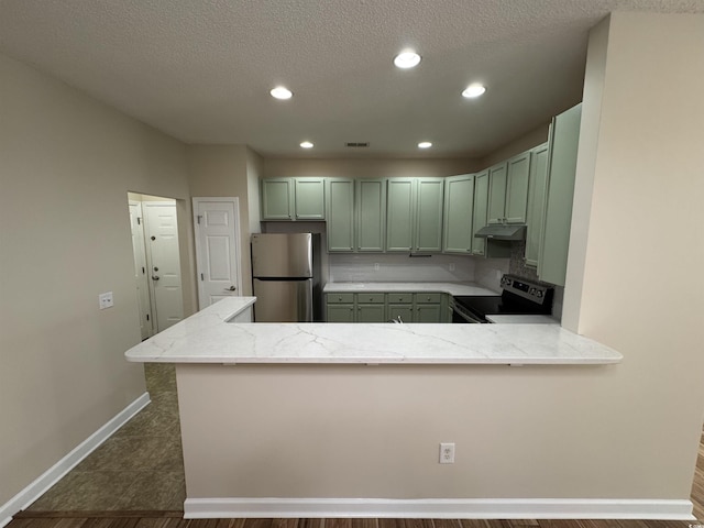 kitchen with kitchen peninsula, backsplash, electric range, stainless steel refrigerator, and light stone counters