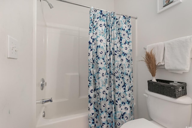 bathroom featuring shower / bath combination with curtain and toilet