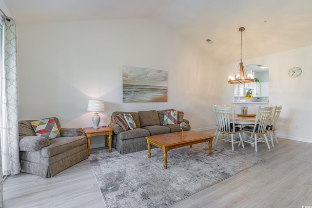 living room with vaulted ceiling and light hardwood / wood-style floors