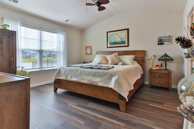 bedroom with ceiling fan, vaulted ceiling, and dark hardwood / wood-style floors