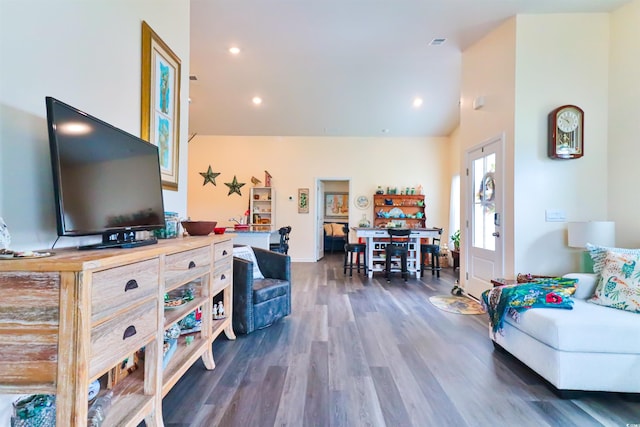 living room with high vaulted ceiling and dark hardwood / wood-style floors