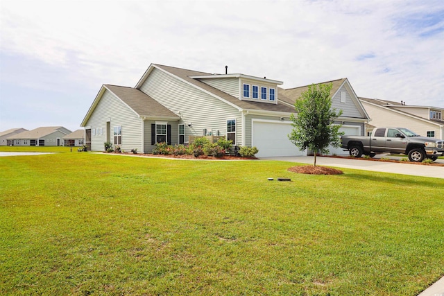 view of property featuring a front lawn and a garage