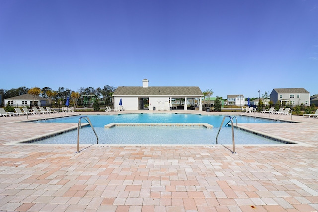 view of swimming pool featuring a patio area