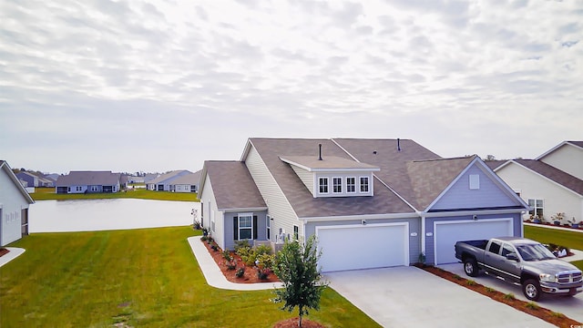 view of front of house featuring a garage and a front lawn