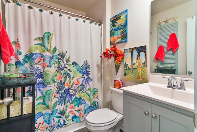 bathroom featuring toilet and vanity