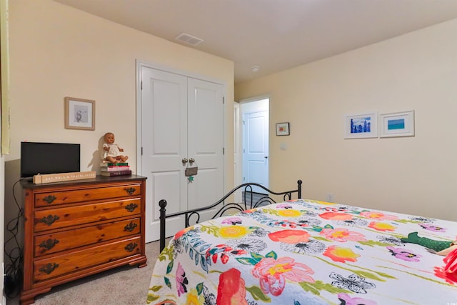 bedroom with a closet and light colored carpet