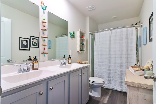 bathroom with vanity, hardwood / wood-style floors, a shower with curtain, and toilet