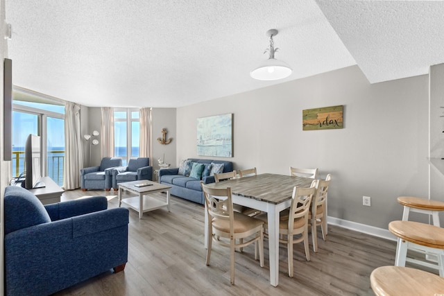 dining area featuring hardwood / wood-style floors and a textured ceiling