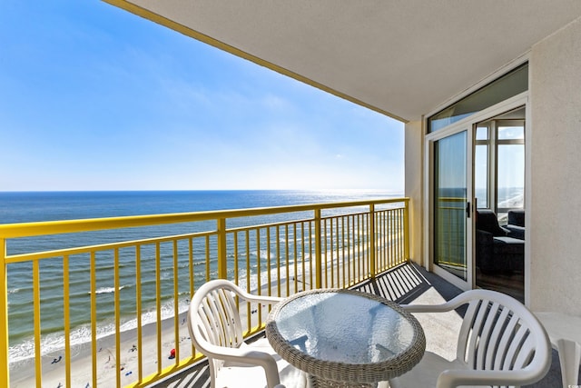 balcony with a water view and a beach view