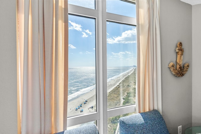 interior space with a beach view and a water view