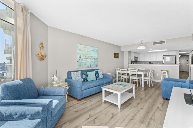 living room with light hardwood / wood-style flooring