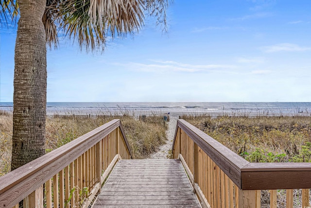 view of home's community with a beach view and a water view