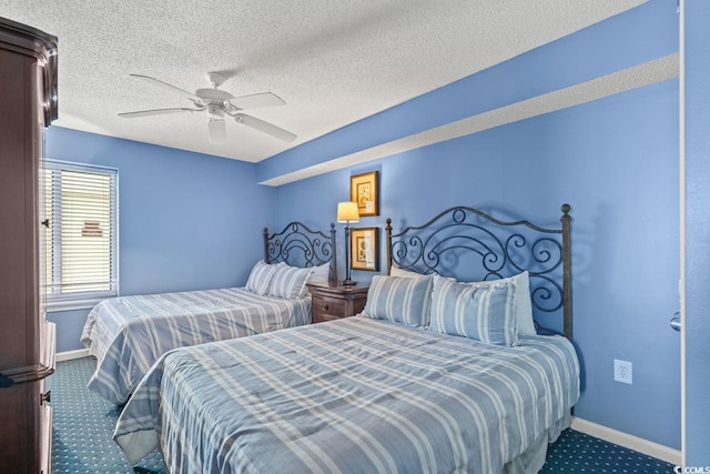 bedroom featuring a textured ceiling, baseboards, ceiling fan, and carpet