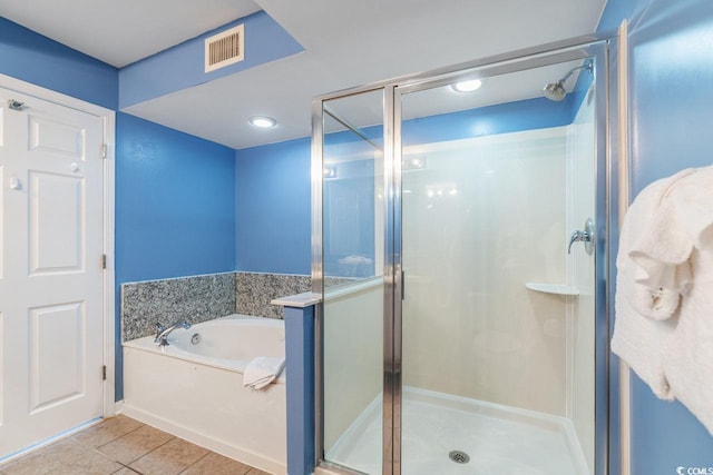 full bathroom with tile patterned flooring, a shower stall, a garden tub, and visible vents