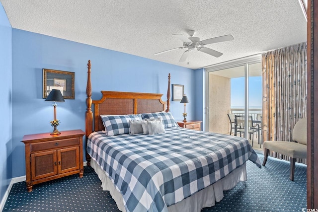 carpeted bedroom with a ceiling fan, a textured ceiling, access to exterior, and expansive windows