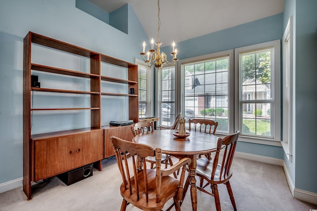 dining space featuring a notable chandelier, light carpet, and high vaulted ceiling