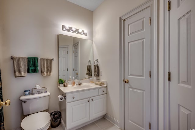 bathroom featuring toilet, vanity, and tile patterned floors