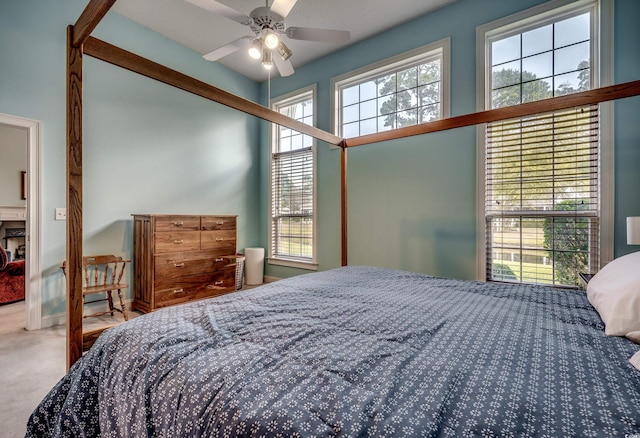 carpeted bedroom with multiple windows and ceiling fan