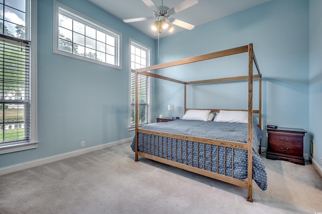 bedroom featuring light colored carpet and ceiling fan