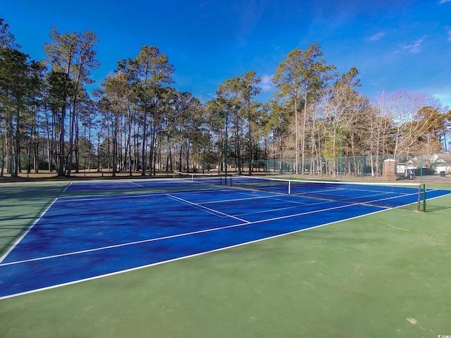 view of tennis court with basketball hoop